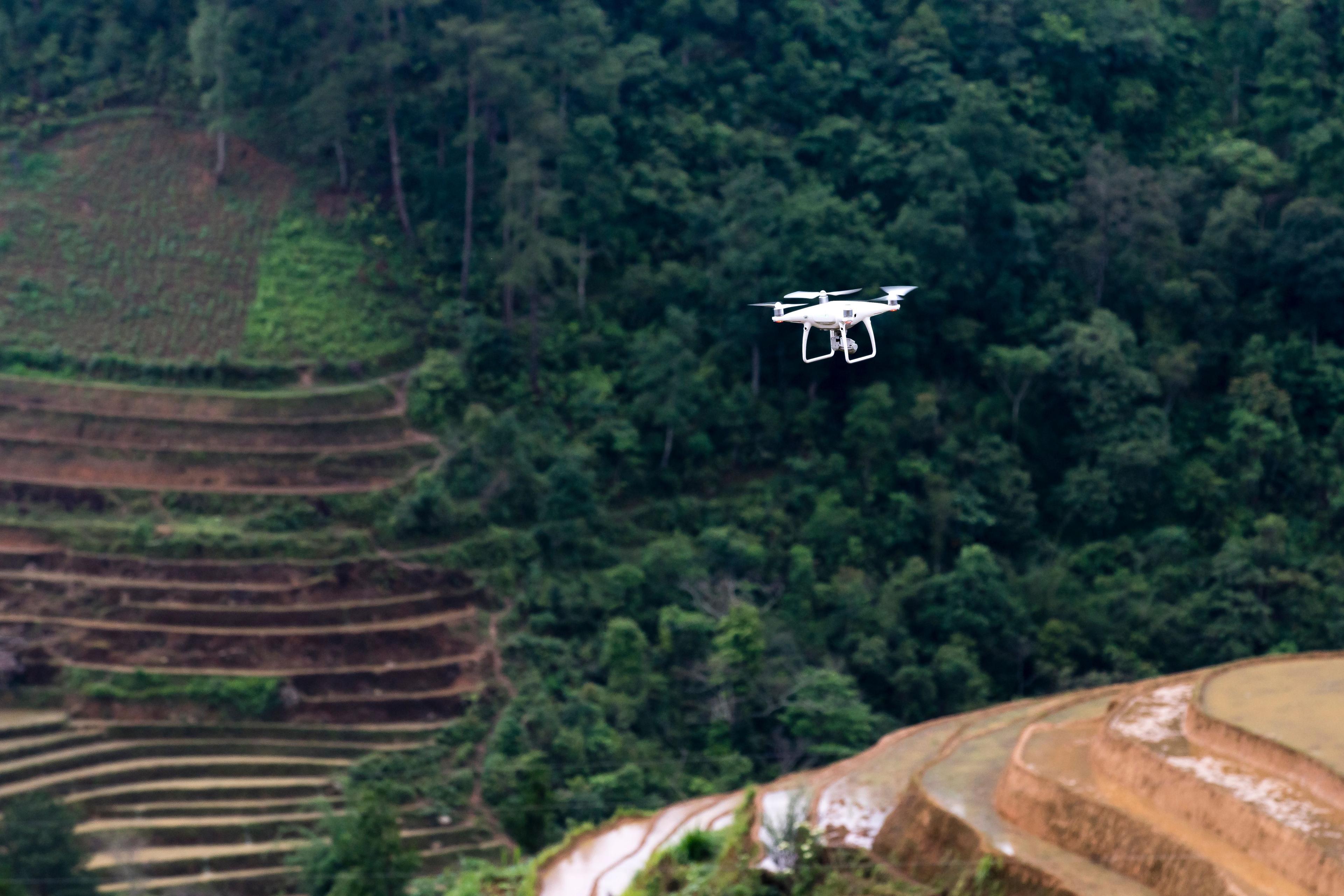 A camera drone in flight against an open sky