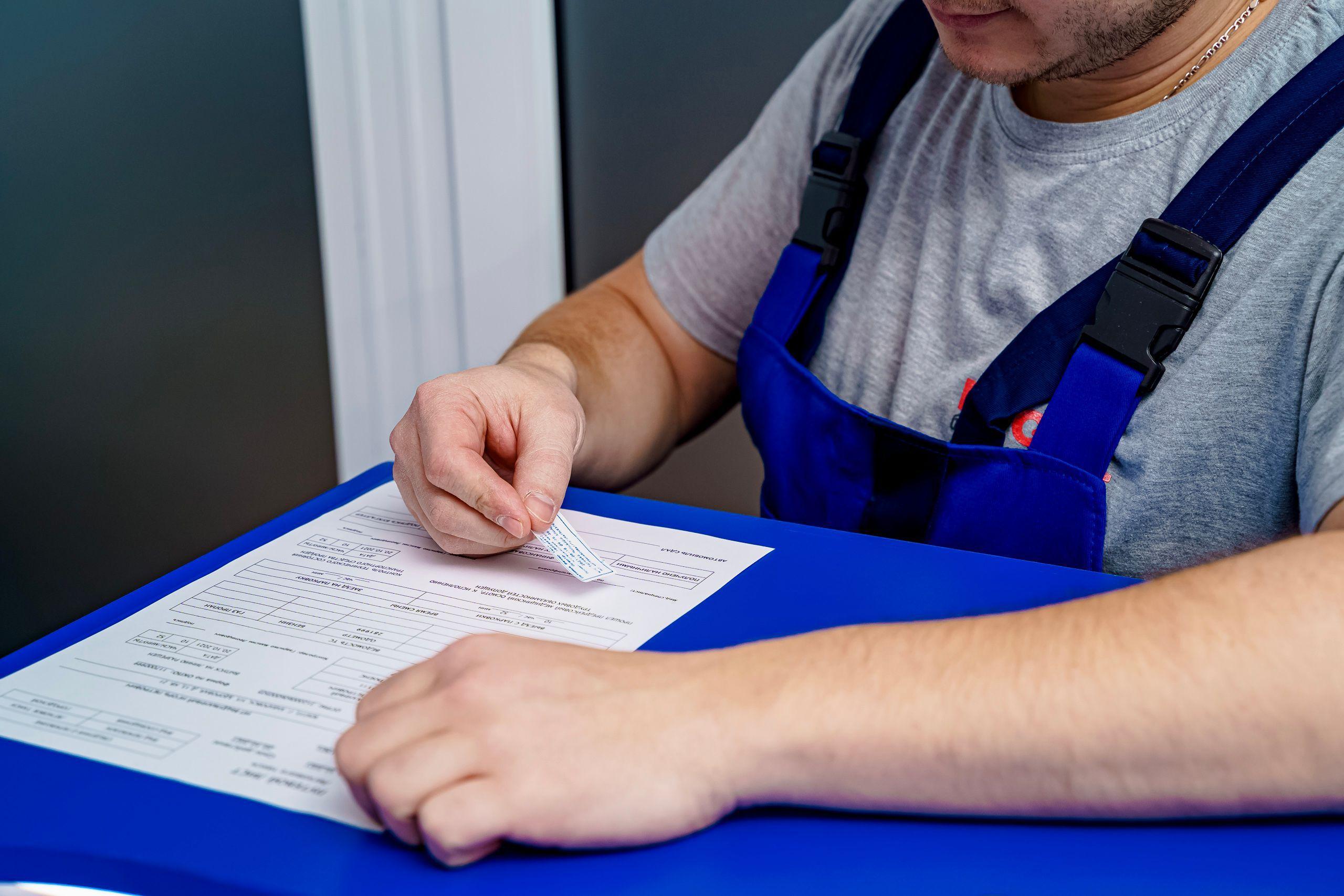 A worker filling in a work permit document