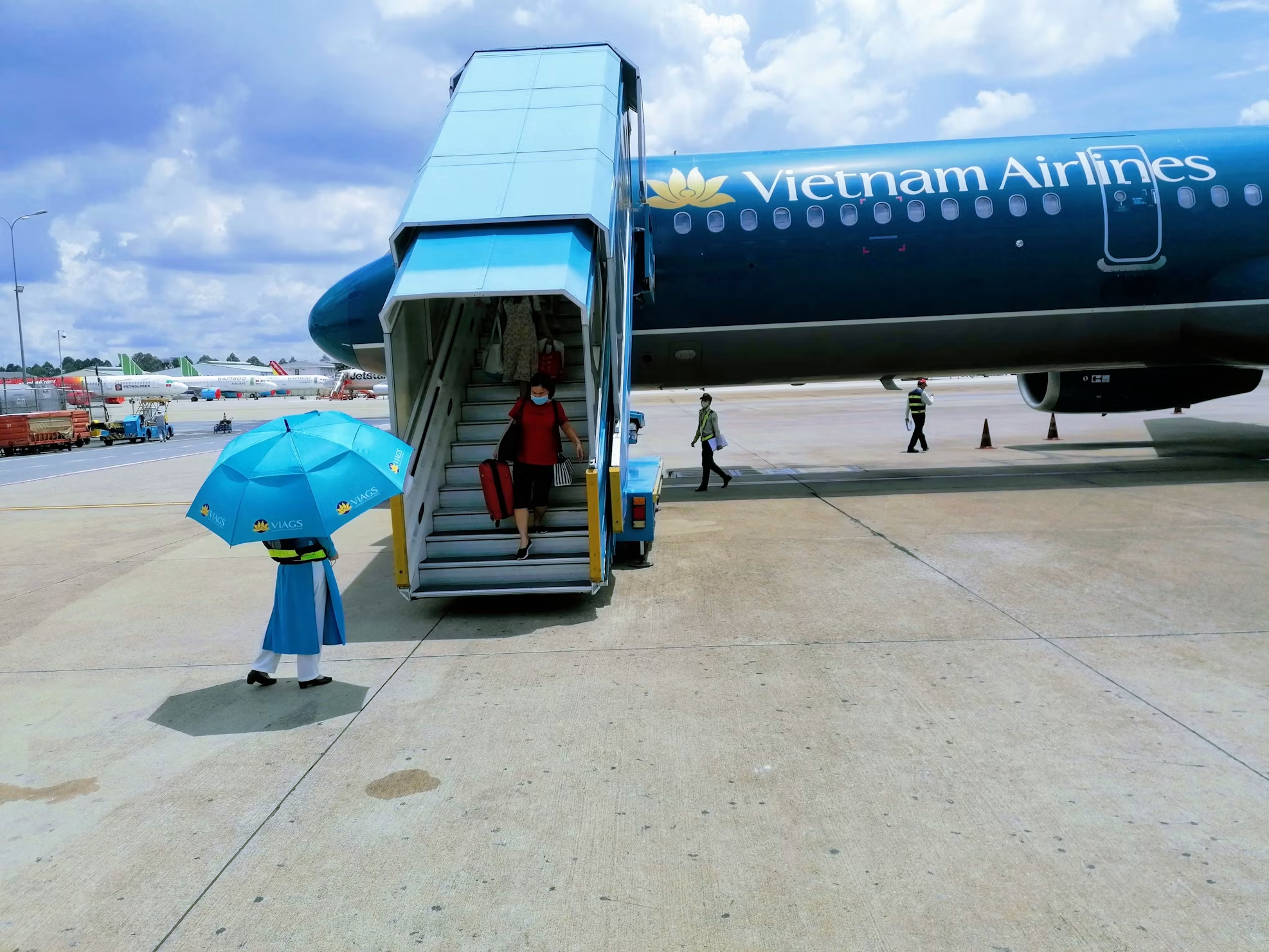 Passengers disembarking at a Vietnamese airport.
